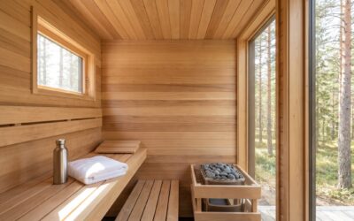 Bright modern sauna interior with a stainless water bottle and folded towel on the bench